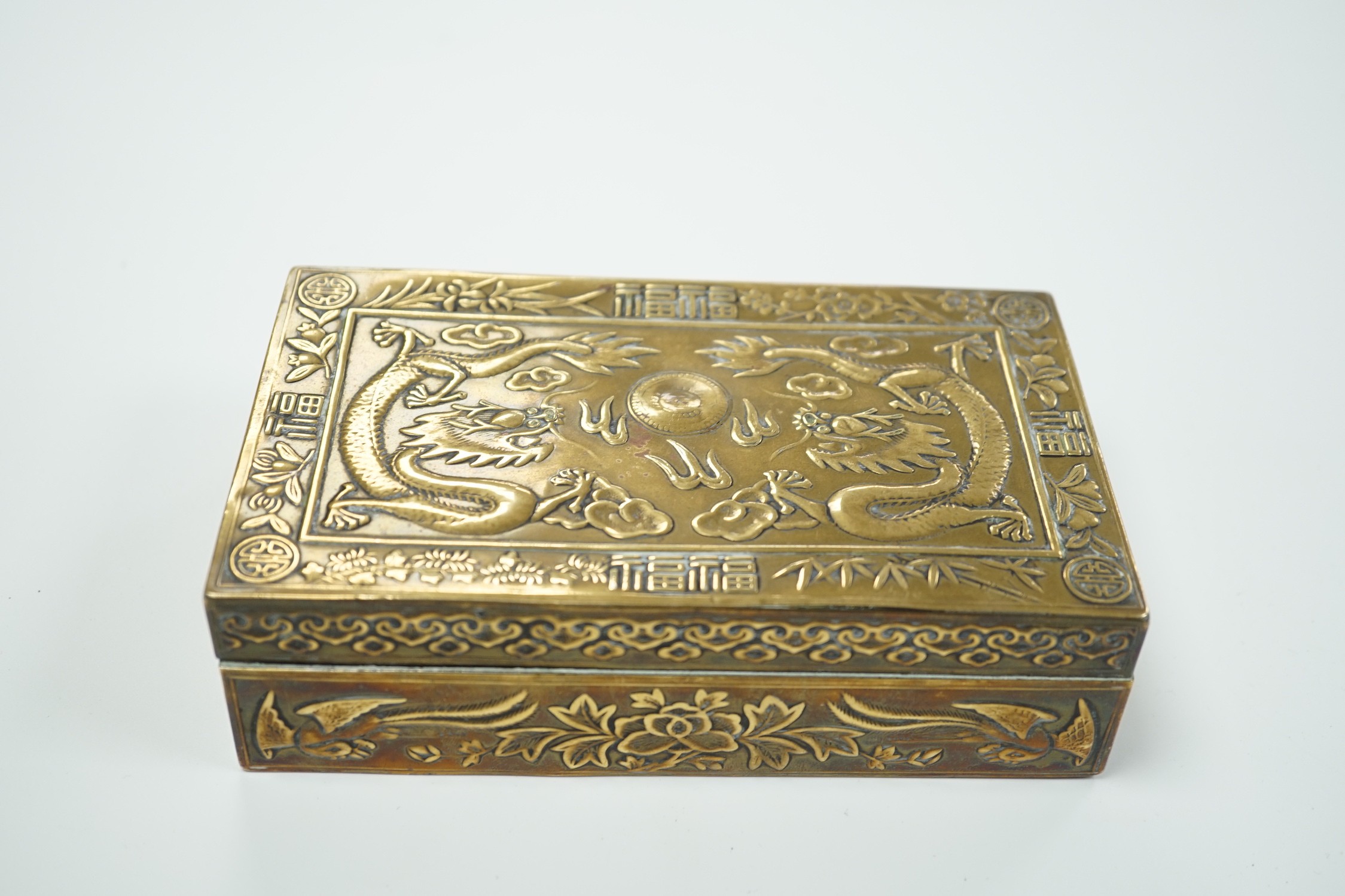 A Chinese brass 'dragon' cigarette box, 15.5cm